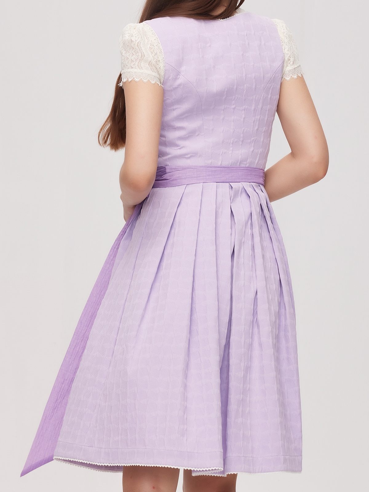 Ein elegantes lila Dirndl mit floralen Details – perfekt für festliche Anlässe.
